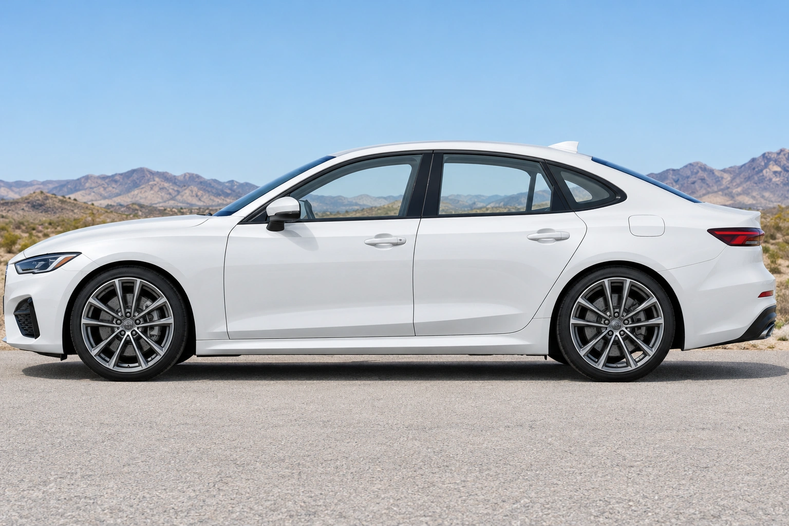 White sedan in side profile with Arizona mountains visible through its windows