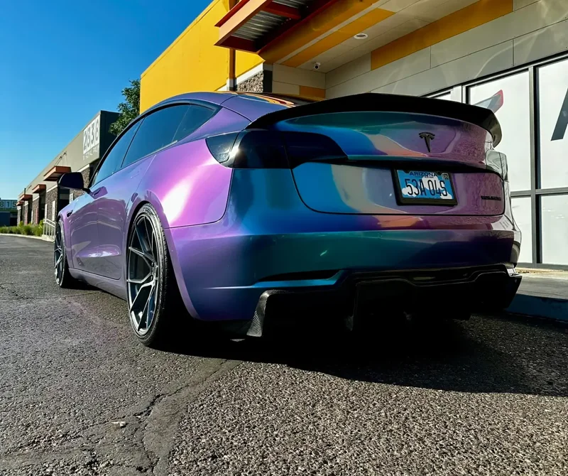 Rear view of a color-shift Tesla outside Vader Tint